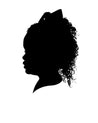 Black silhouette portrait of a girl with curly hair and a big hair bow