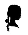 Silhouette portrait of a child with a braided ponytail and bow